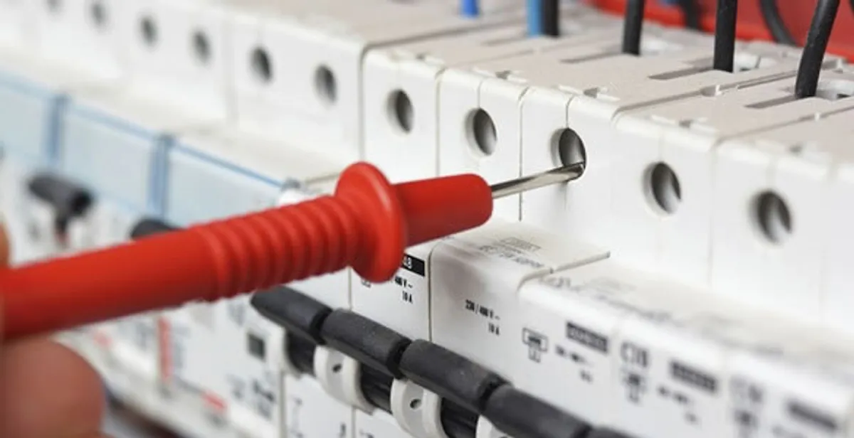Electrical contractor testing circuit breakers during electrical repair in Guilderland, NY