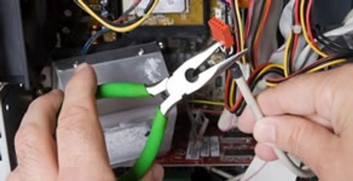 Licensed electrical contractor performing electrical repair with tools in Delmar, NY