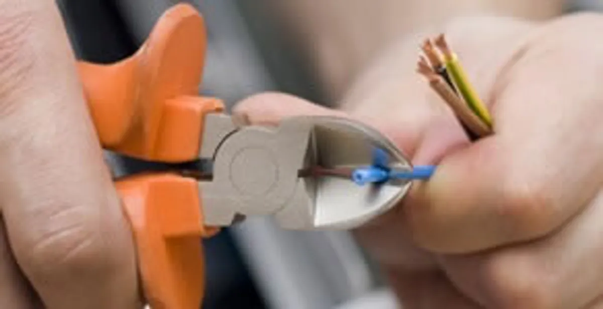 professional electrical services showing precise wire cutting by licensed electricians in Albany, NY